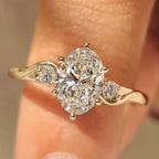 Three Stone Style Oval Cut Engagement Ring with Round Side Stone