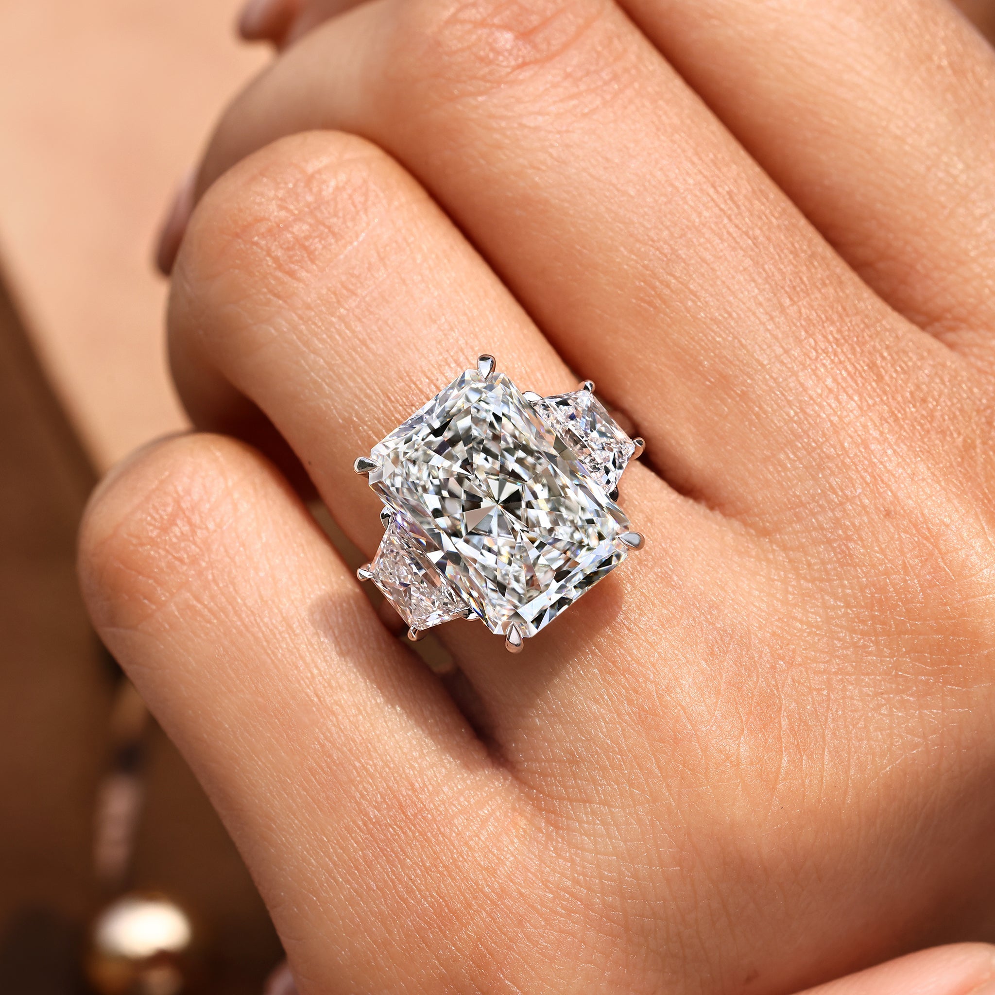 10 - 14 Carat Radiant Cut Diamond Ring with Trapezoid Side Stones