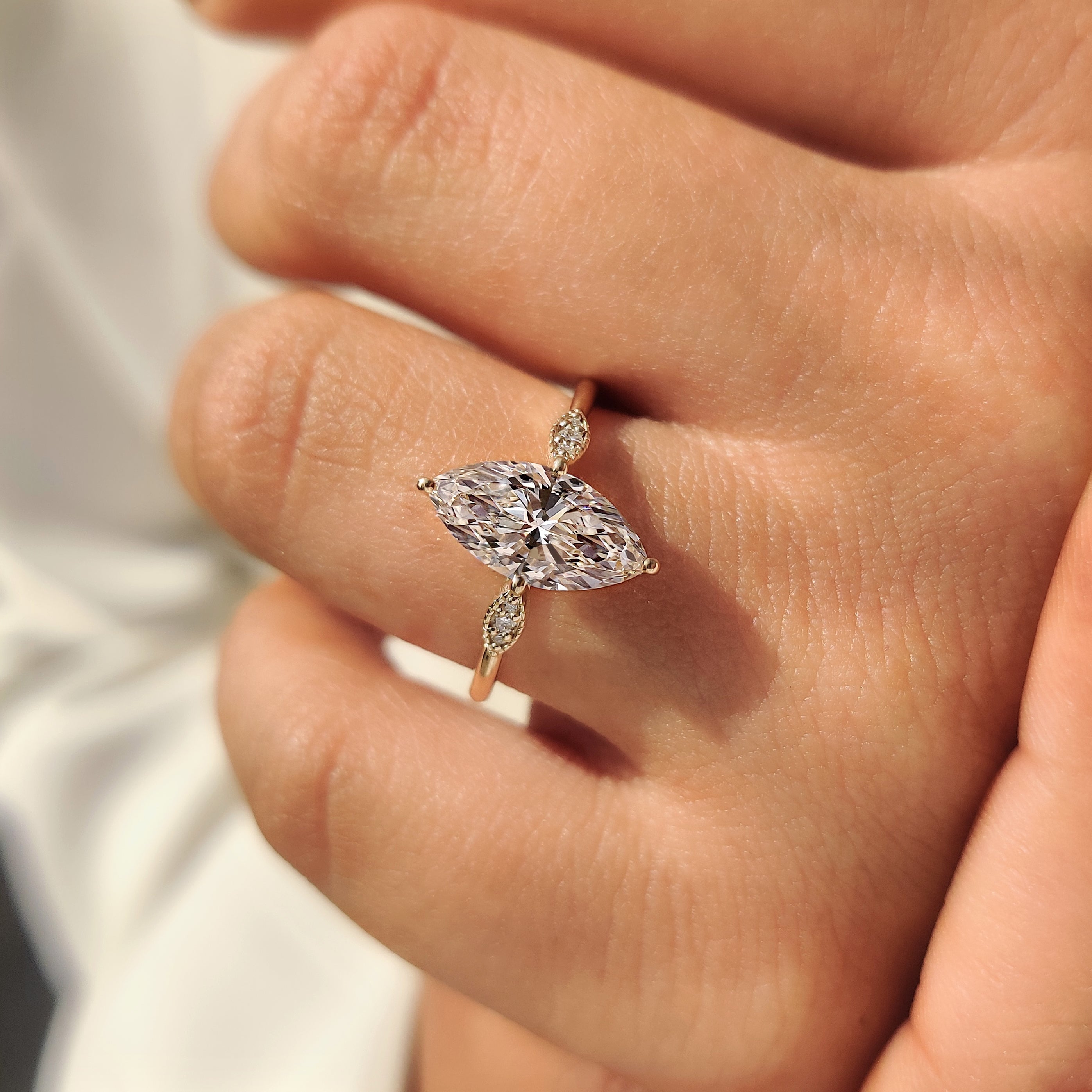 Marquise Cut Diamond Ring with Round Side Stones