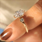 Three Stone Style Oval Cut Engagement Ring with Round Side Stone