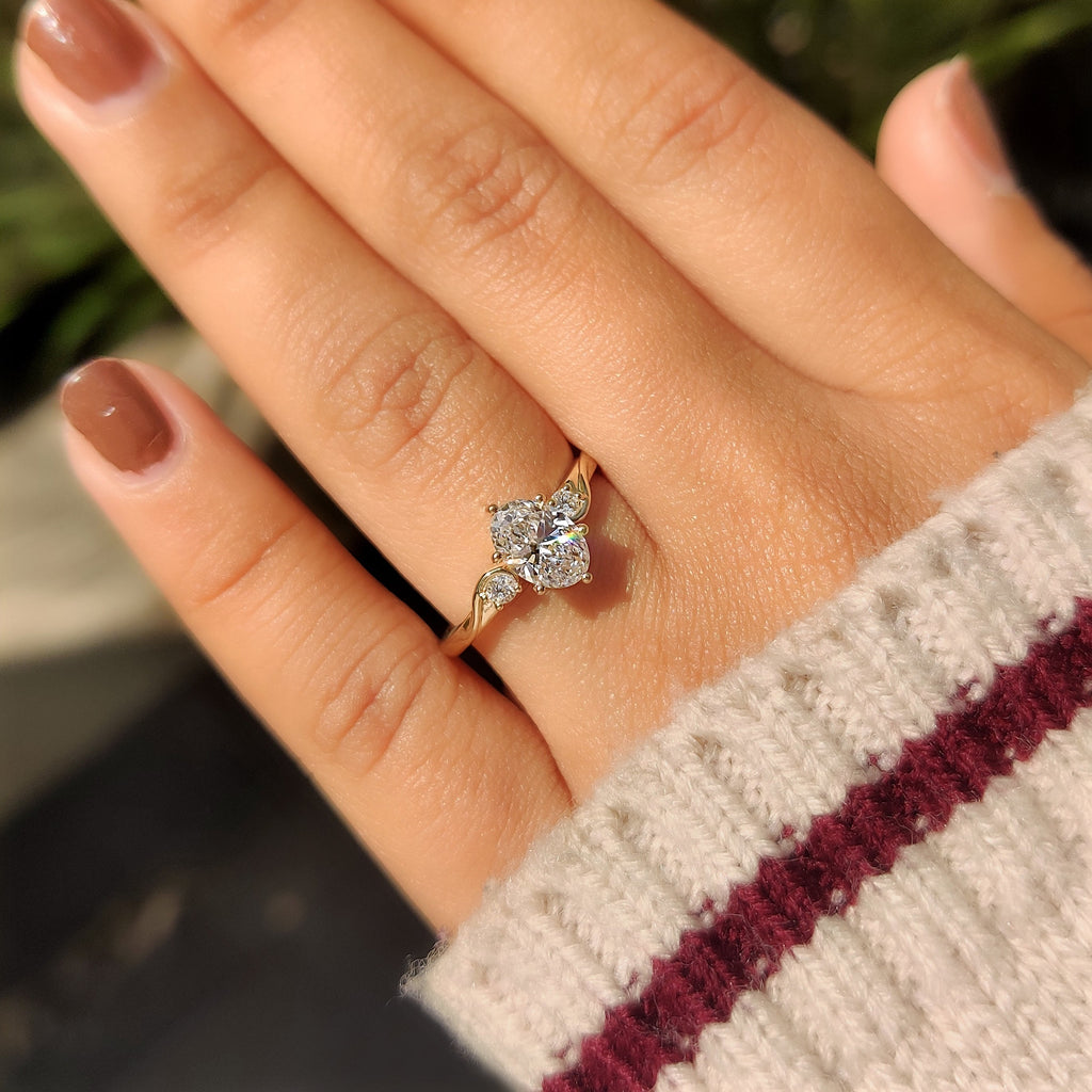 Three Stone Style Oval Cut Engagement Ring with Round Side Stone