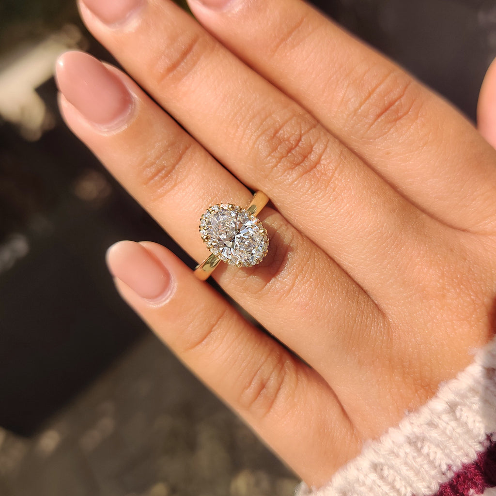 Oval Cut Diamond Ring in Round Cut Diamond Basket Setting