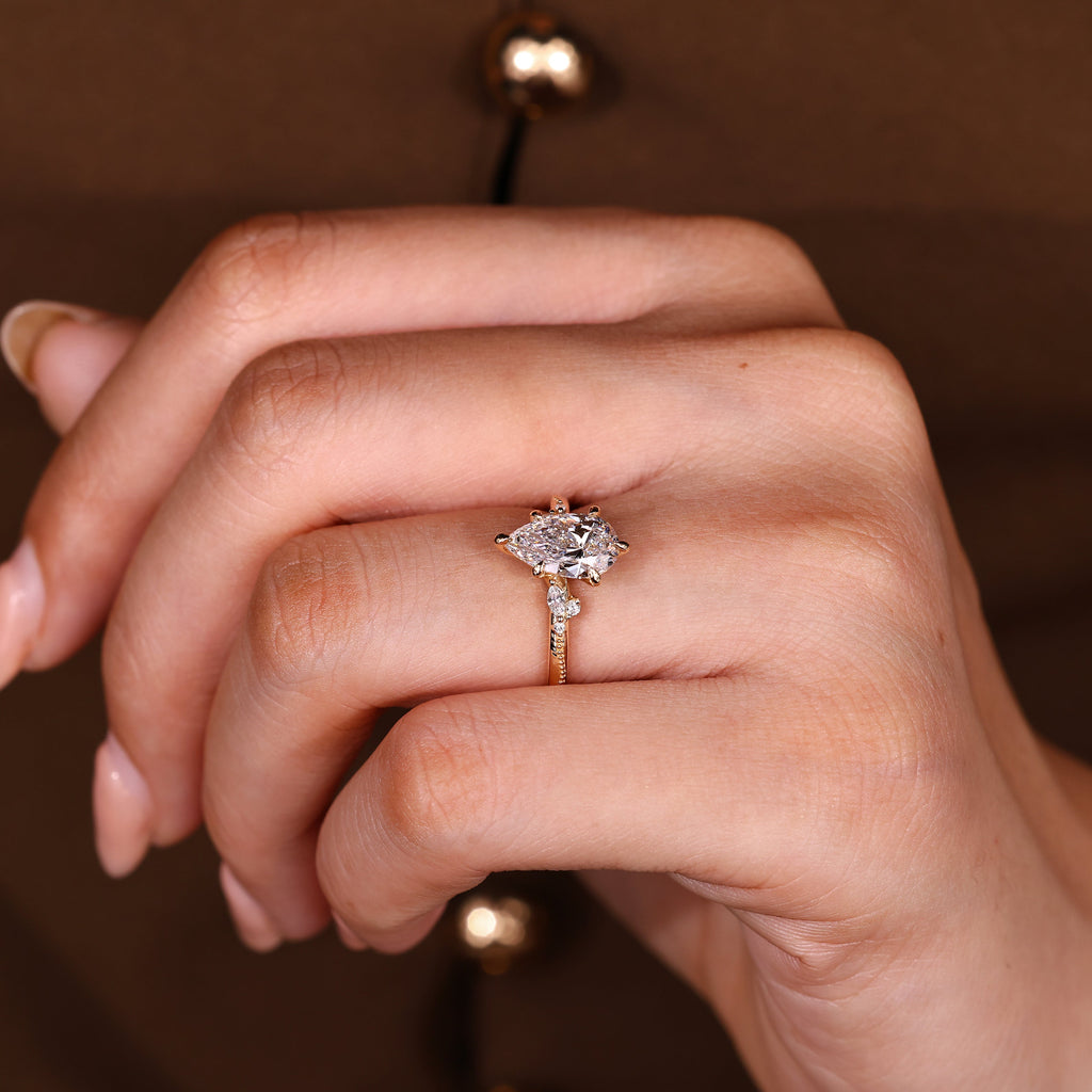 Pear Cut Engagement Ring With Side Stone In Vintage Style