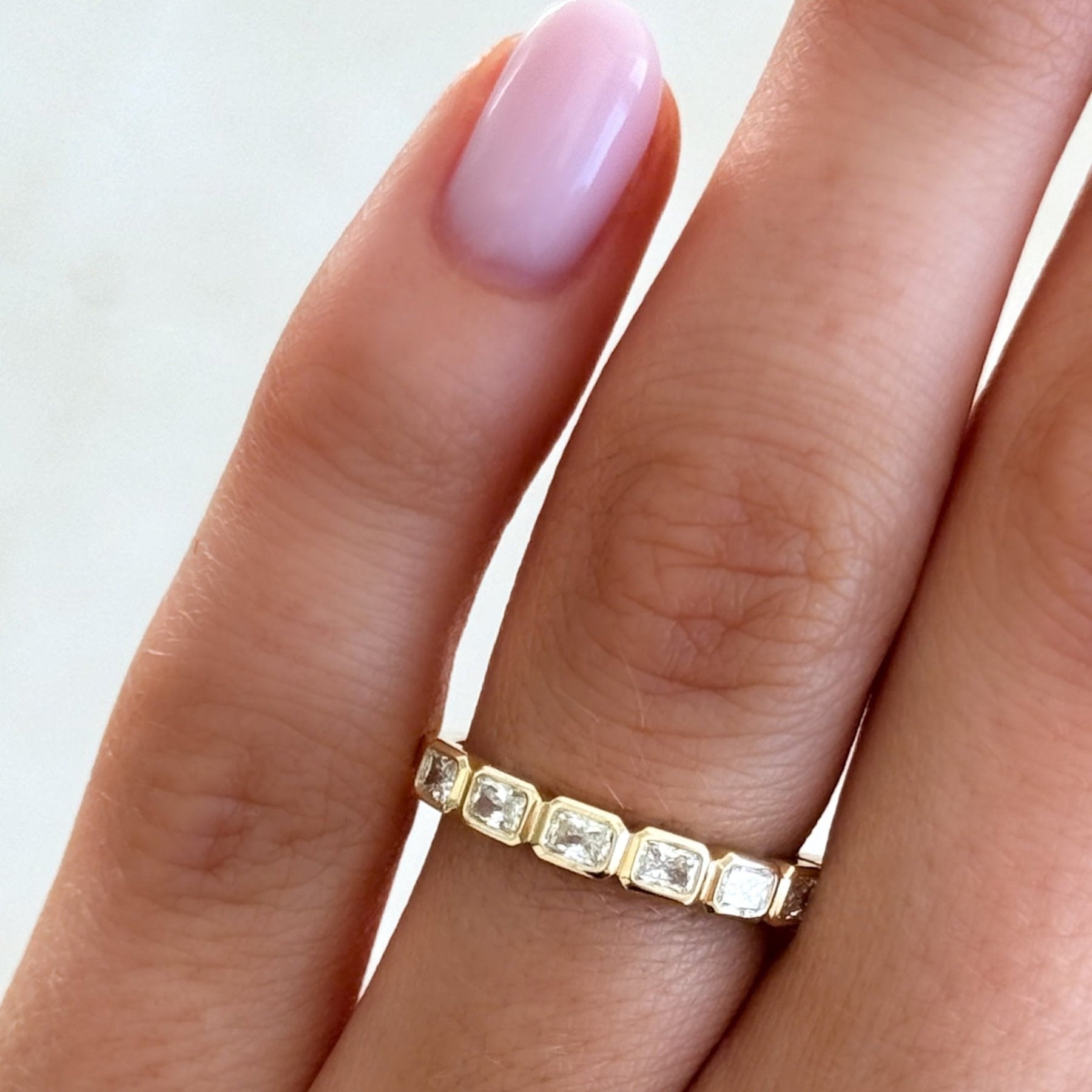 Baby Bezel Set Halfway Wedding Band With East West Radiant Cuts Secondary image