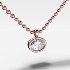 Bezel Set Pendant Beaded Necklace with East West Oval Cut Diamond
