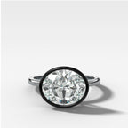Blackened Penumbra Bezel Set Engagement Ring With East West Oval Cut