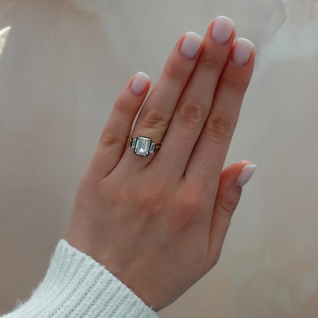 Blackened Three Stone Engagement Ring With Straight Baguette Side Stones and Emerald Cut Diamond