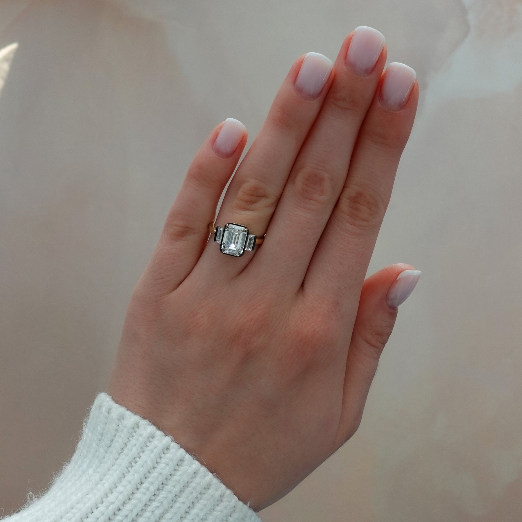 Blackened Three Stone Engagement Ring With Straight Baguette Side Stones and Emerald Cut Diamond