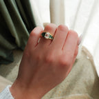 Brick Road Engagement Ring with Green Emeralds and an Emerald Cut
