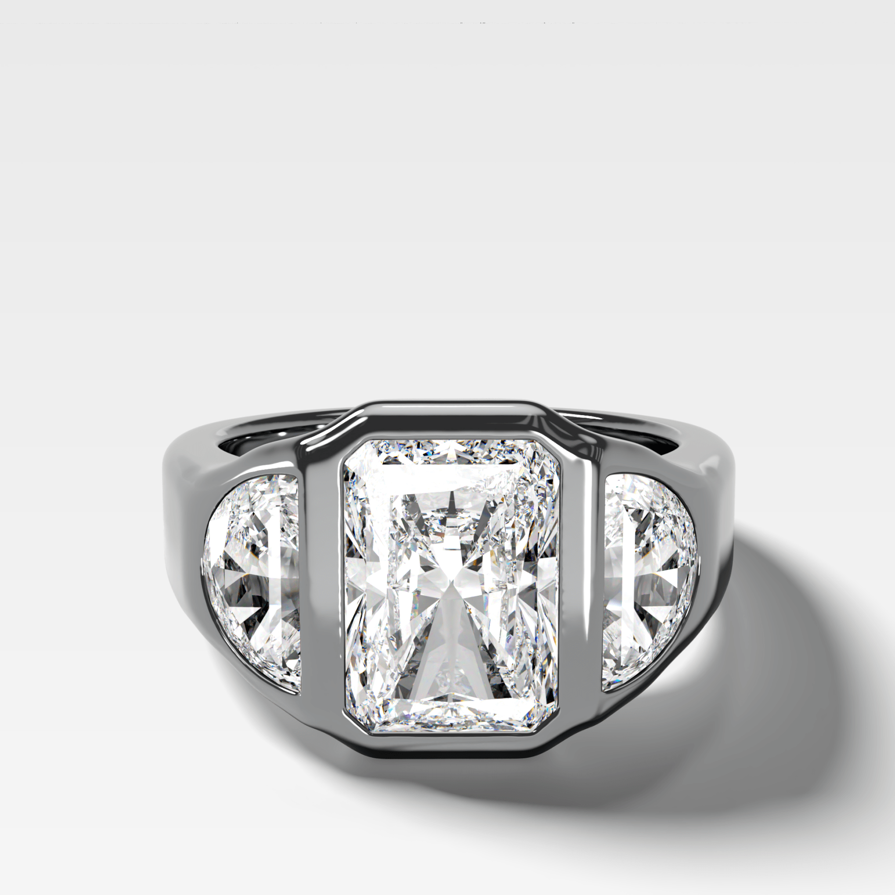 Burnished Three Stone Engagement Ring with Half Moon Sides and an Elongated Radiant Cut Diamond