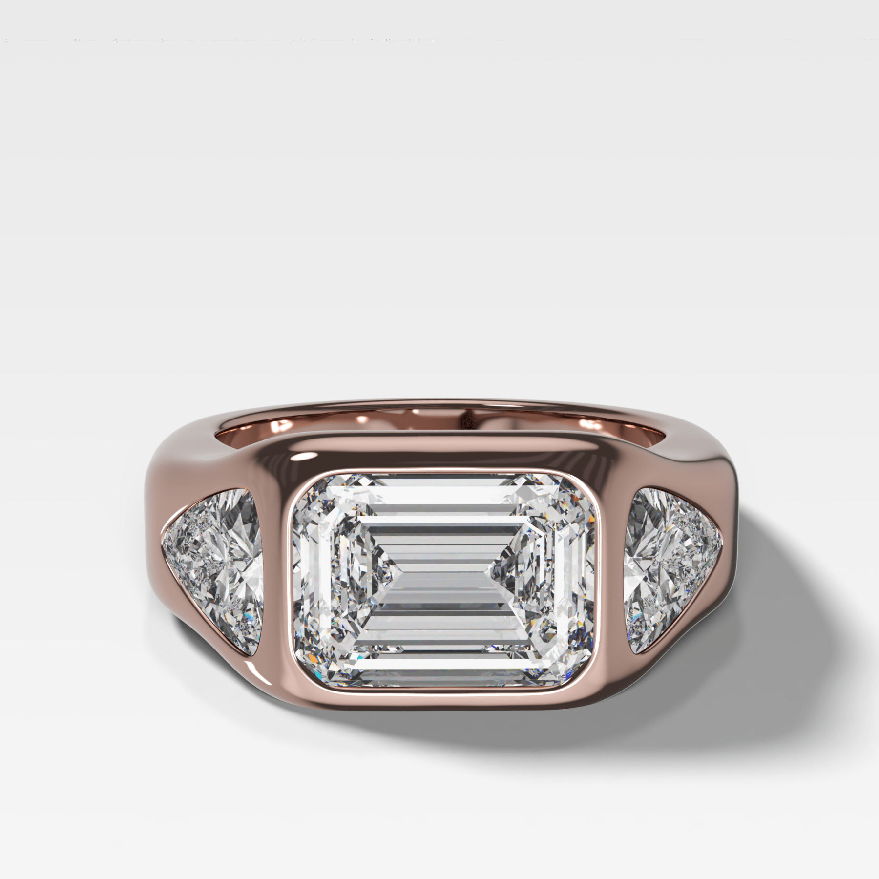 Burnished Three Stone Engagement Ring with Trilliant Sides and East West Emerald Cut Diamond