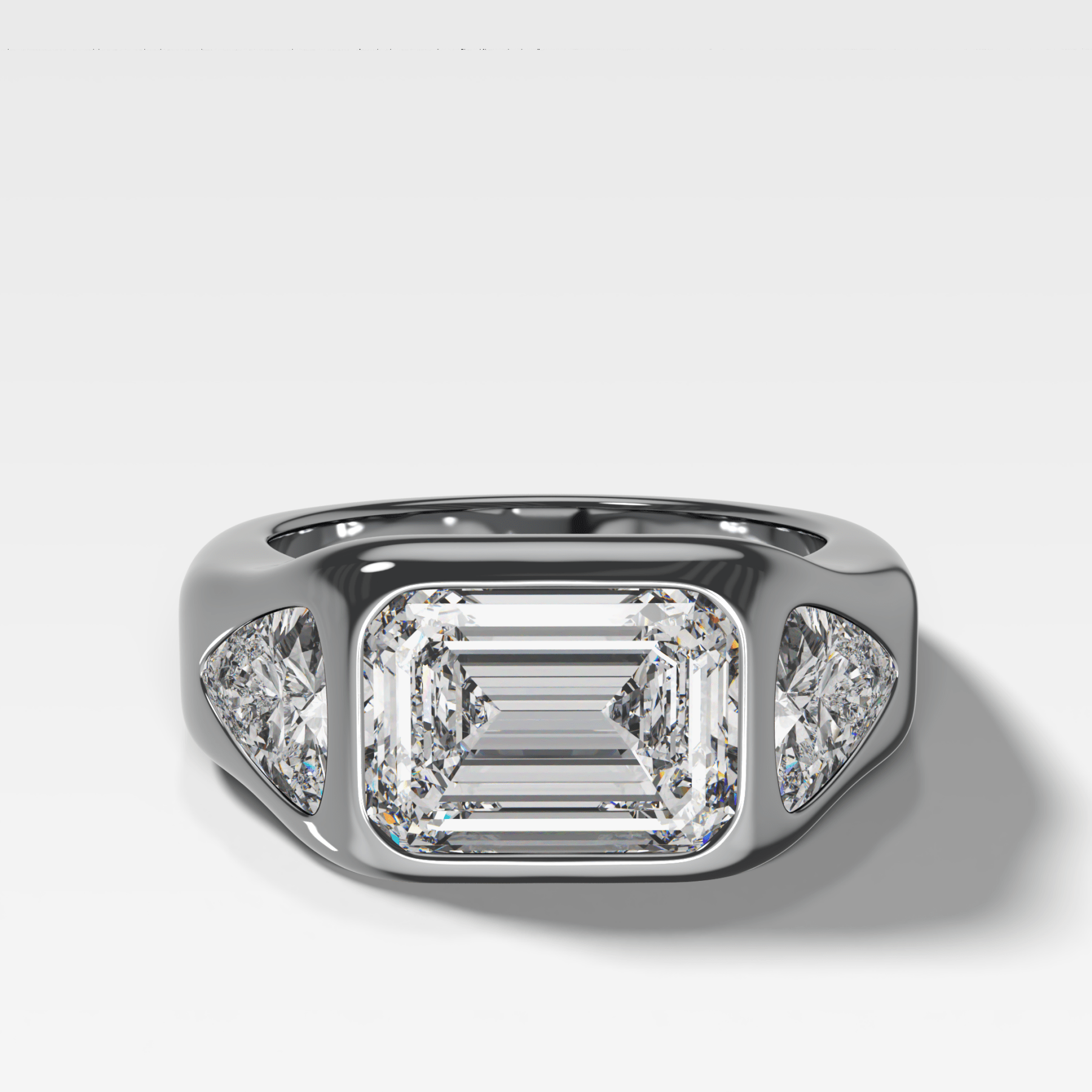 Burnished Three Stone Engagement Ring with Trilliant Sides and East West Emerald Cut Diamond