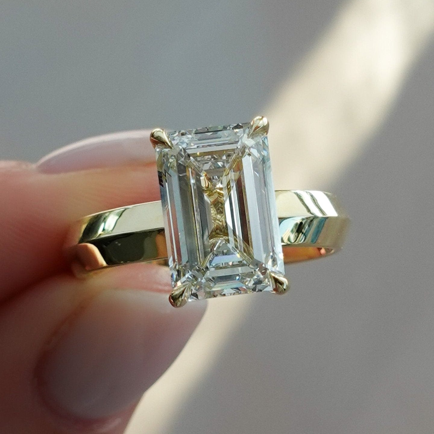 Butter Knife Solitaire Engagement Ring With Emerald Cut Diamond