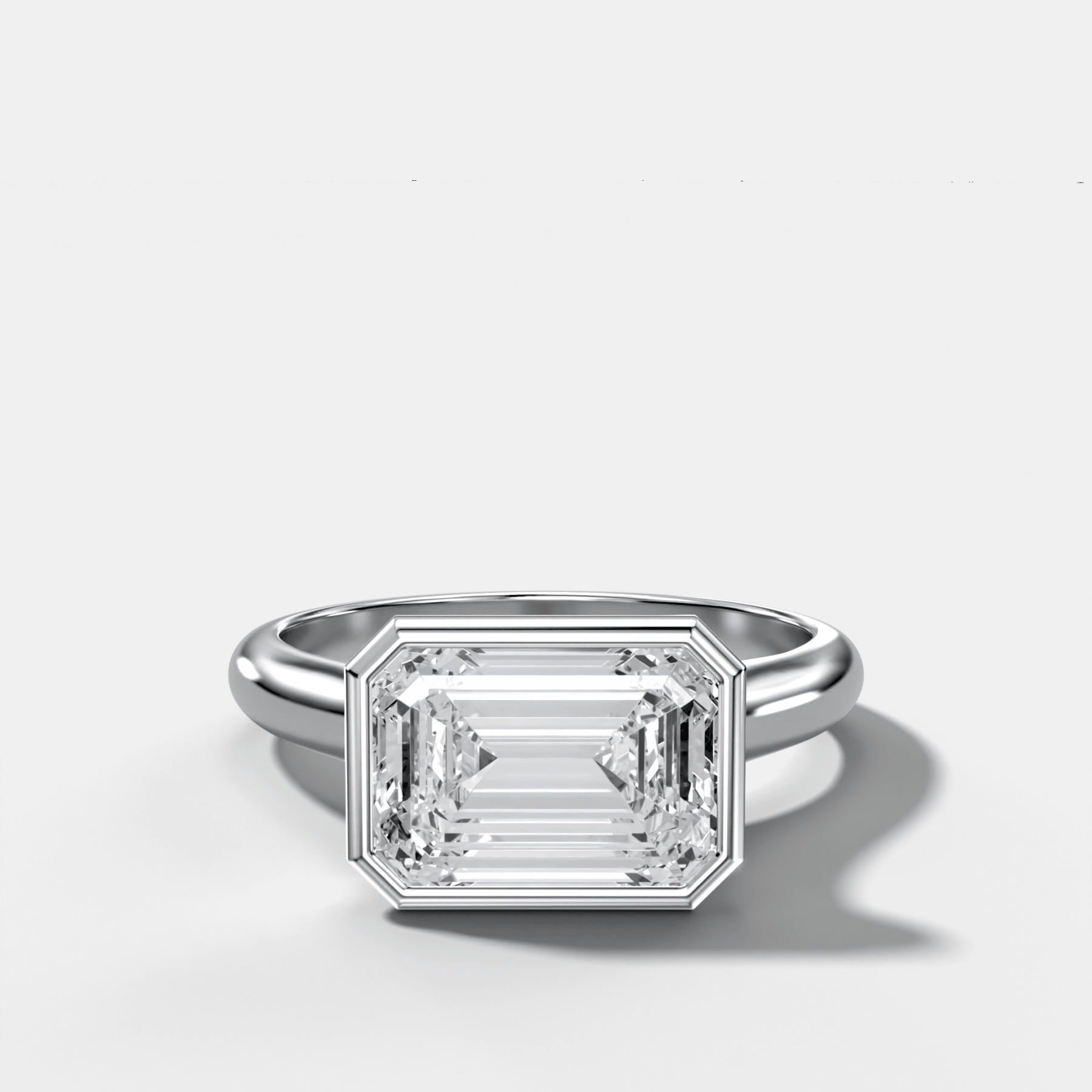 Cathedral Bezel Set Solitaire Engagement Ring With Emerald Cut Diamond (East West)
