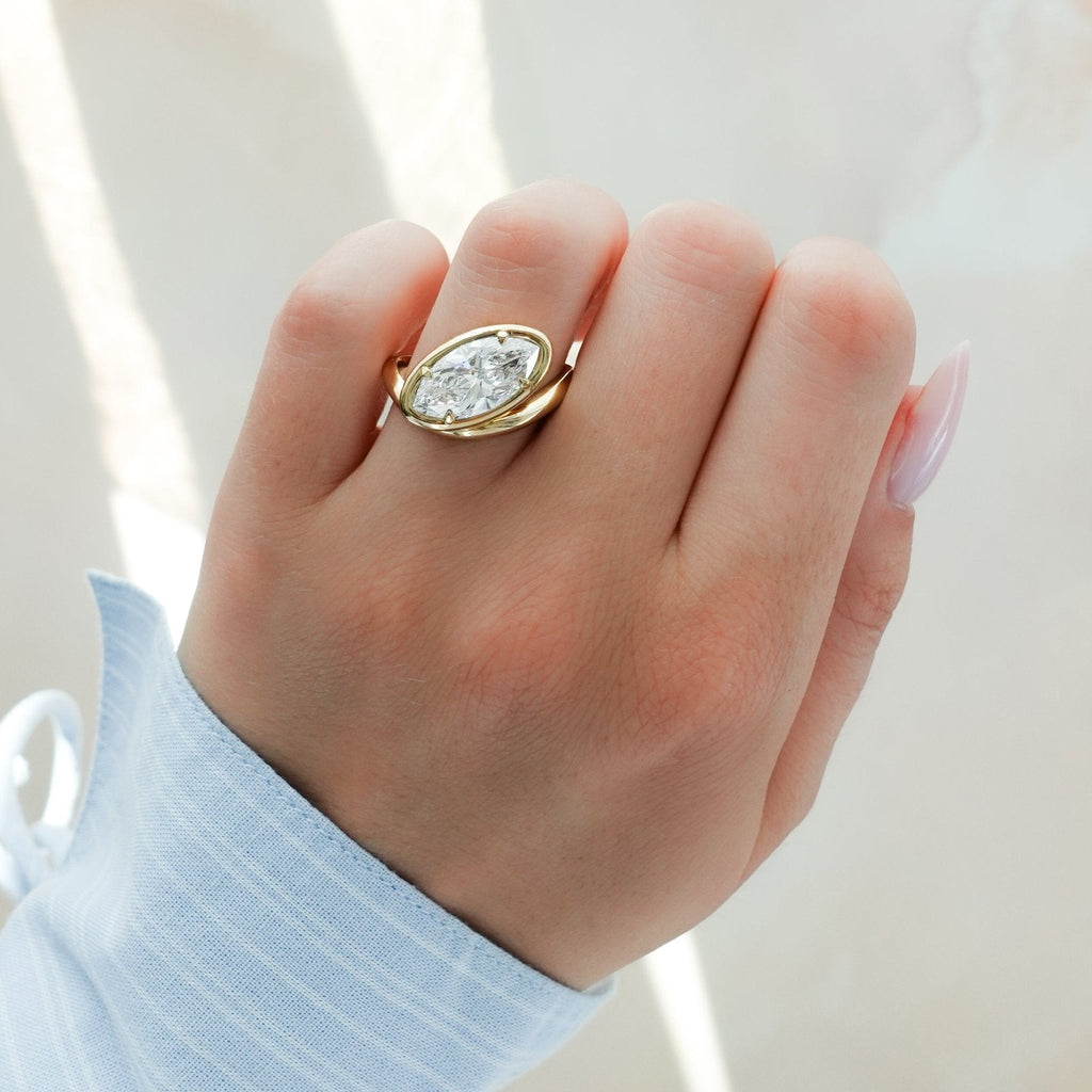Contoured Club Engagement Ring with a Marquise Cut Diamond