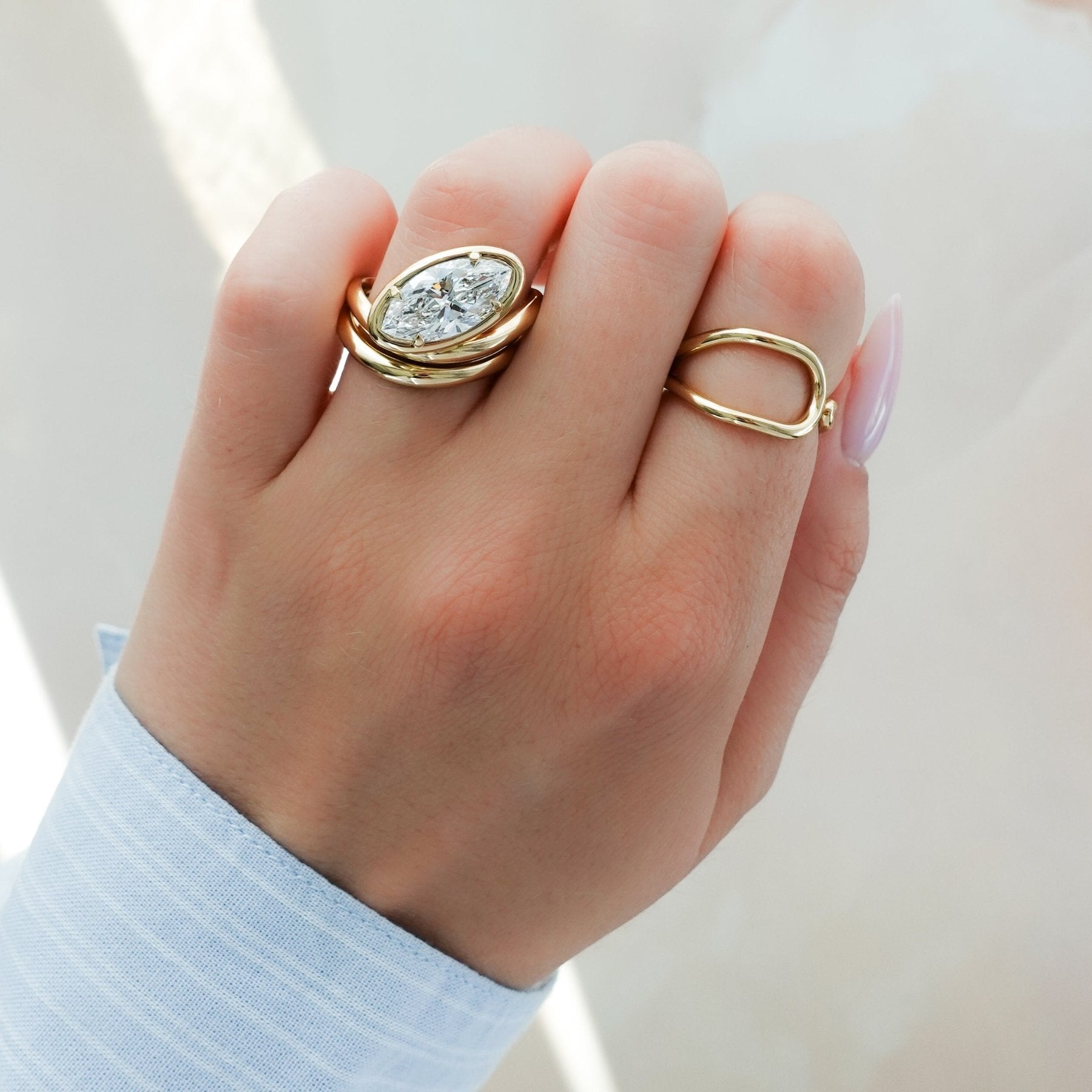 Contoured Club Engagement Ring with a Marquise Cut Diamond