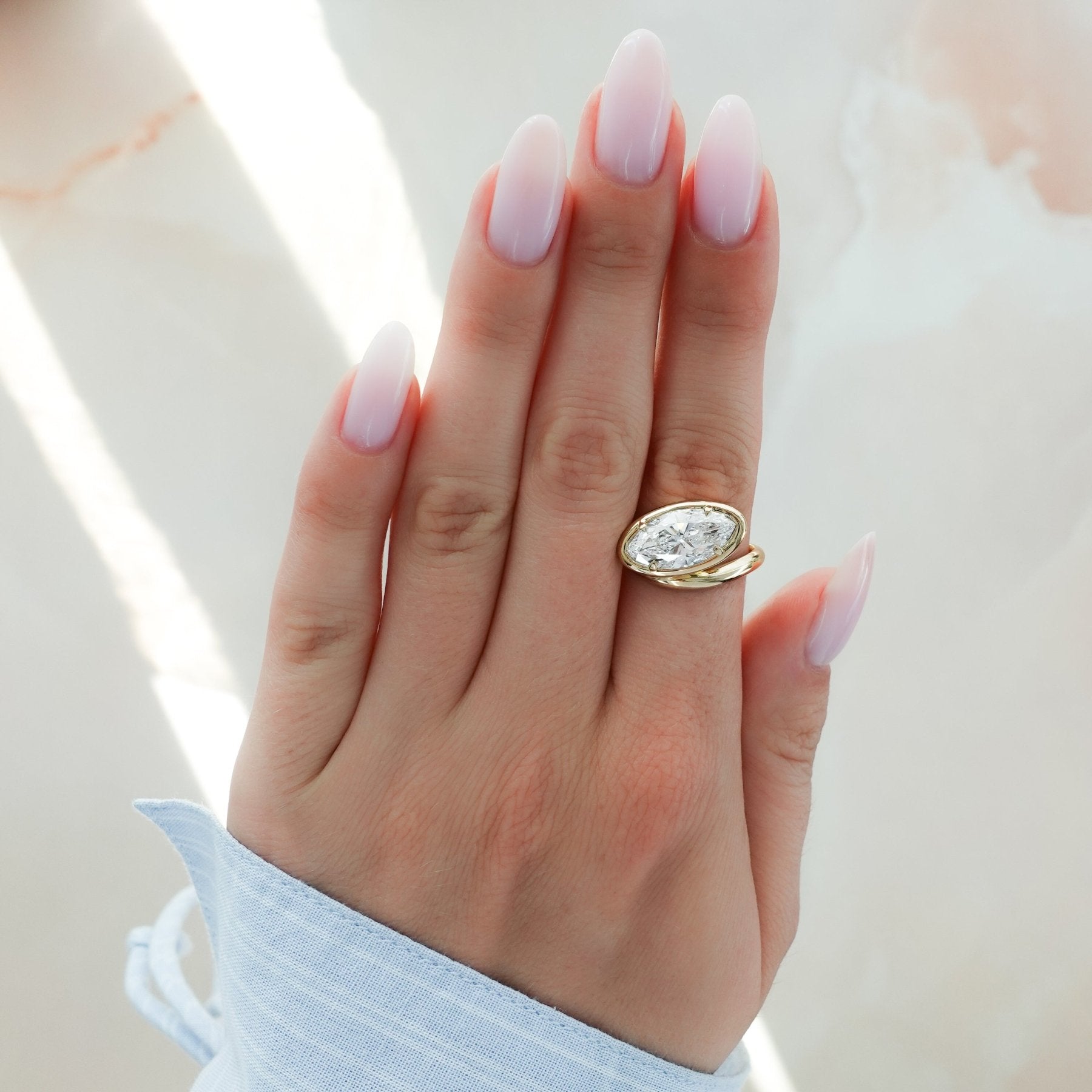 Contoured Club Engagement Ring with a Marquise Cut Diamond