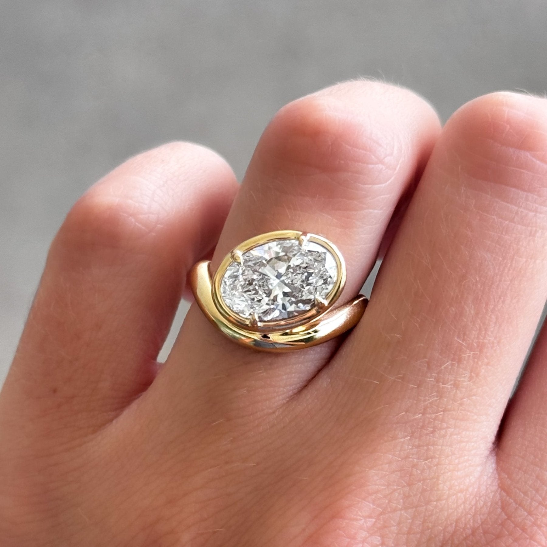 Contoured Club Engagement Ring with an Oval Cut Diamond