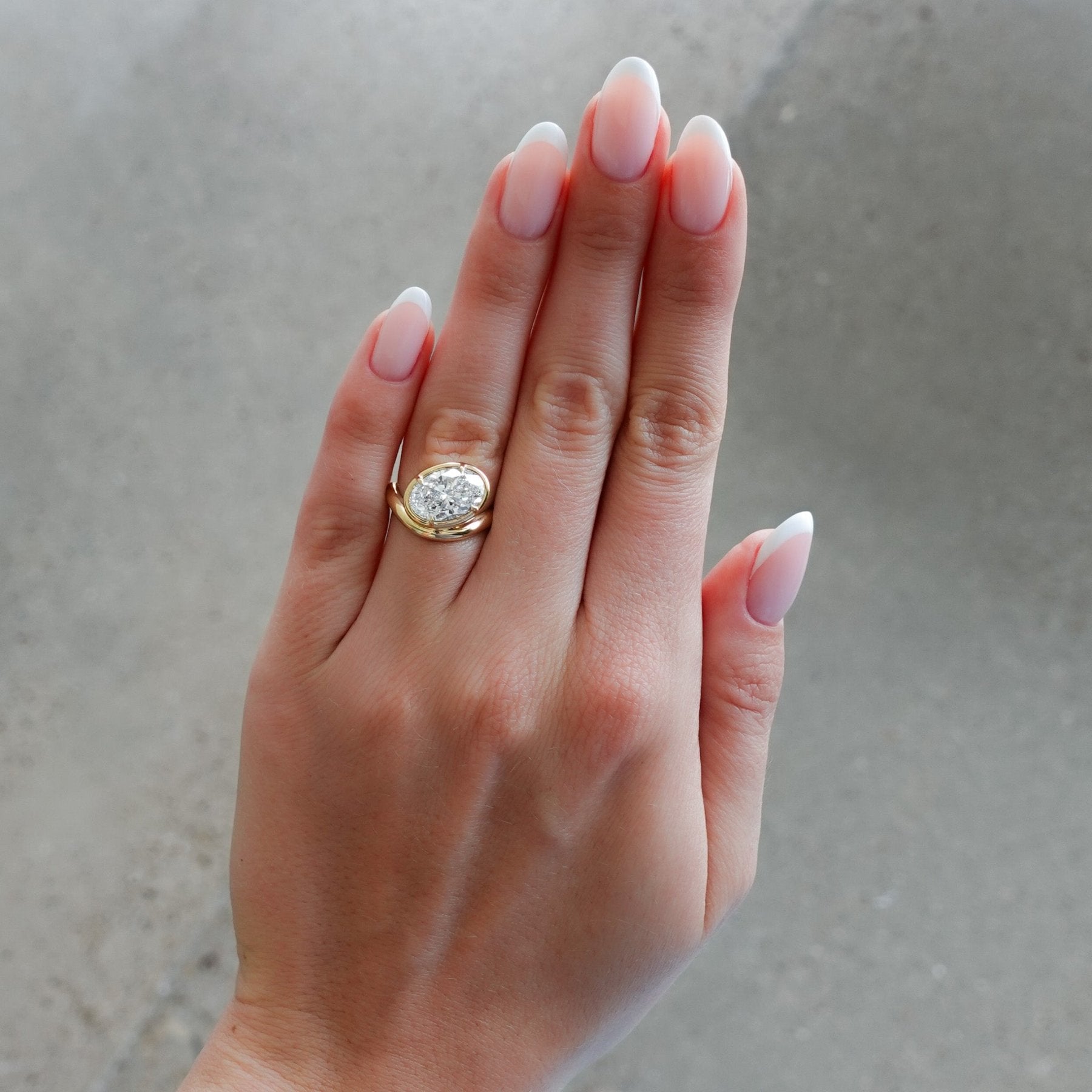 Contoured Club Engagement Ring with an Oval Cut Diamond