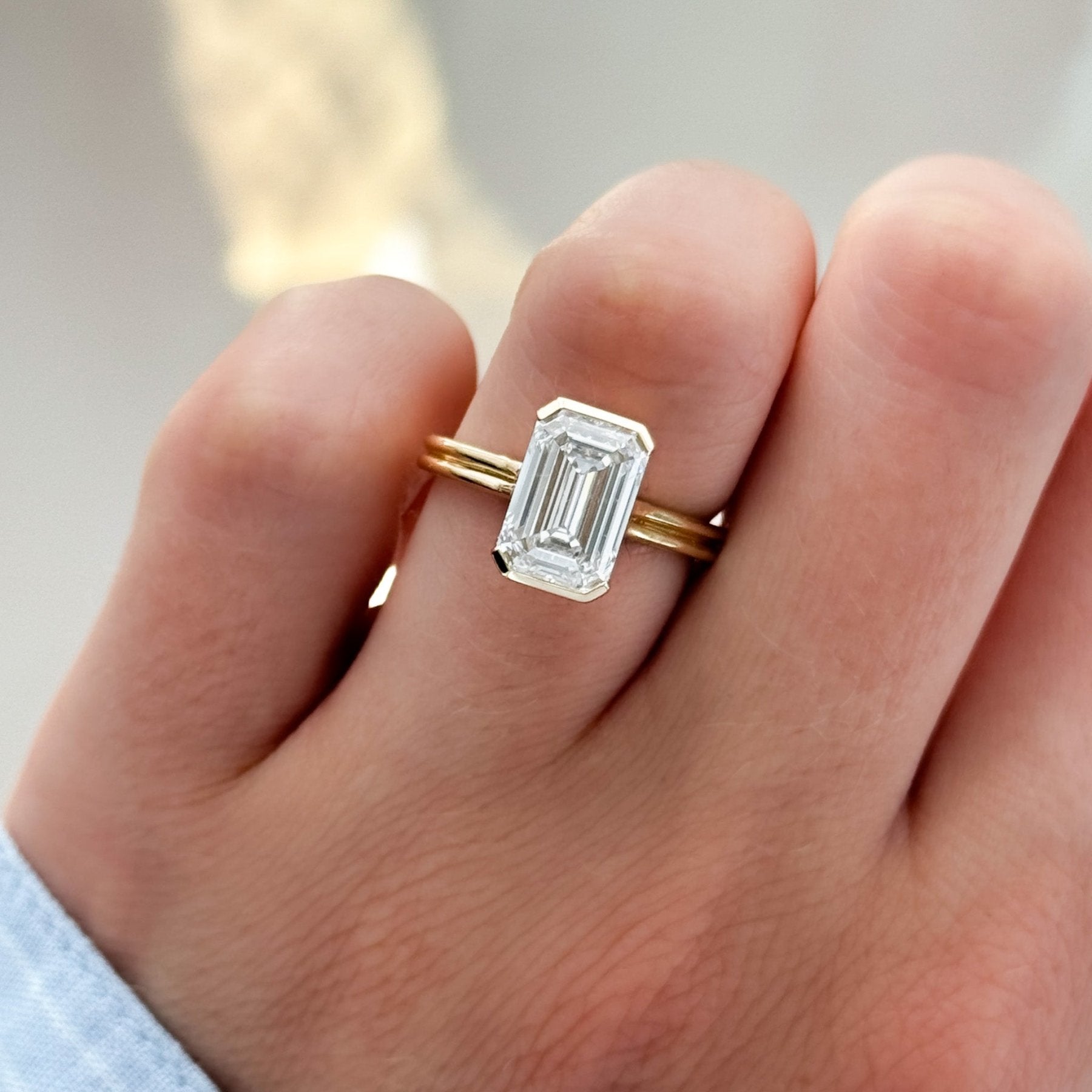 Double Row Half Bezel Solitaire Engagement Ring With Emerald Cut Diamond