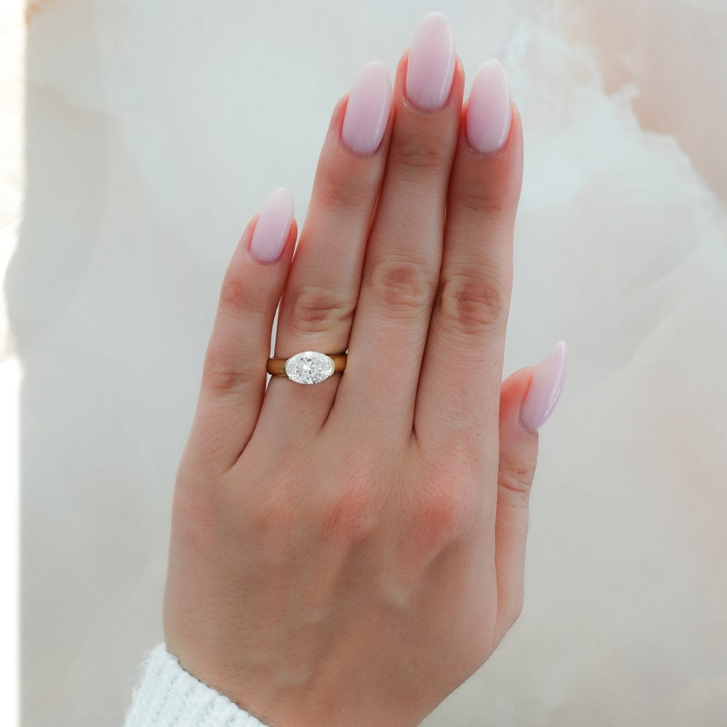 East West Half Bezel 4mm Solitaire Engagement Ring With Oval Cut Diamond