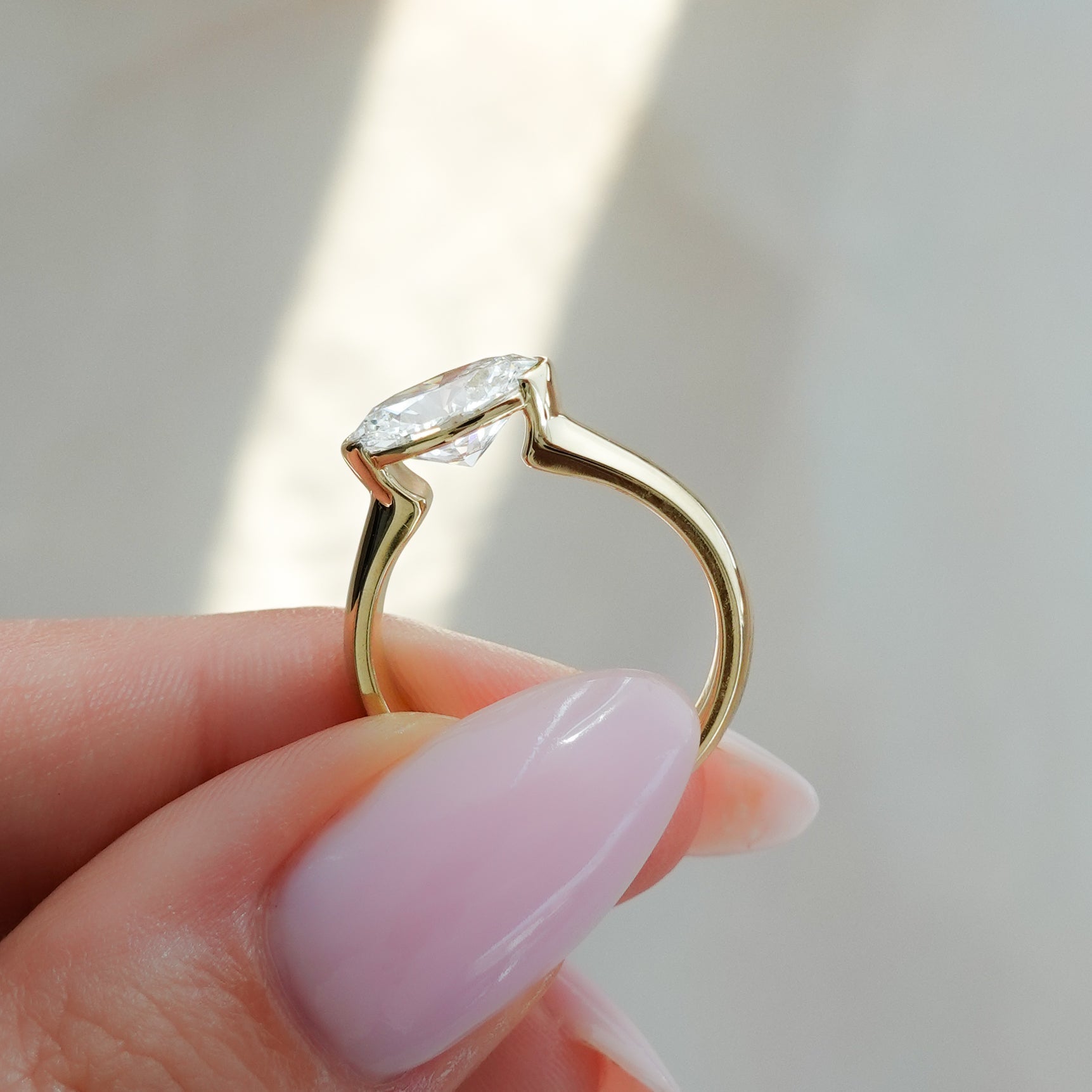 East West Half Bezel 4mm Solitaire Engagement Ring With Oval Cut Diamond