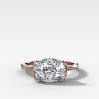East West Half Bezel Solitaire Engagement Ring With Elongated Cushion Cut Diamond