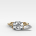 East West Half Bezel Solitaire Engagement Ring With Elongated Cushion Cut Diamond