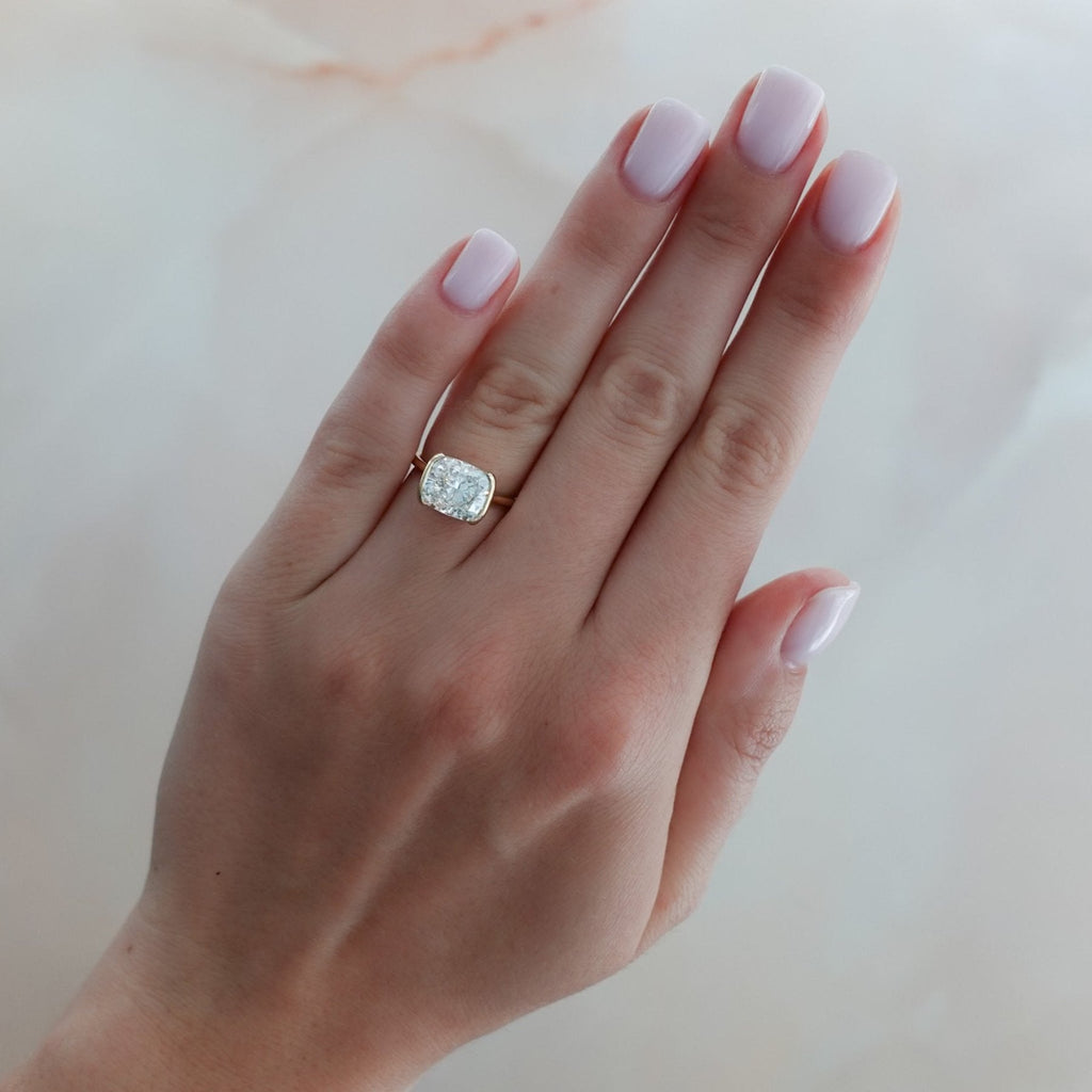 East West Half Bezel Solitaire Engagement Ring With Elongated Cushion Cut Diamond