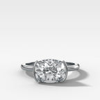 East West Half Bezel Solitaire Engagement Ring With Elongated Cushion Cut Diamond