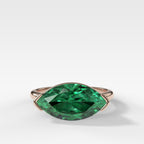 East West Half Bezel Solitaire Engagement Ring With Marquise Cut Green Emerald
