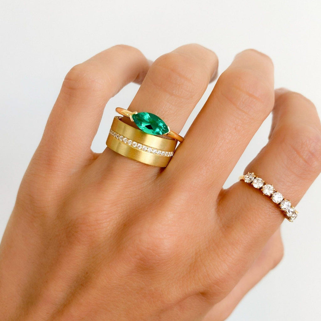 East West Half Bezel Solitaire Engagement Ring With Marquise Cut Green Emerald