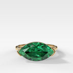 East West Half Bezel Solitaire Engagement Ring With Marquise Cut Green Emerald