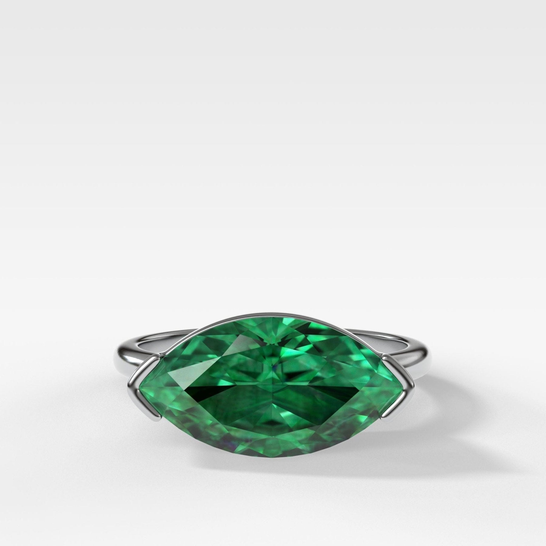 East West Half Bezel Solitaire Engagement Ring With Marquise Cut Green Emerald