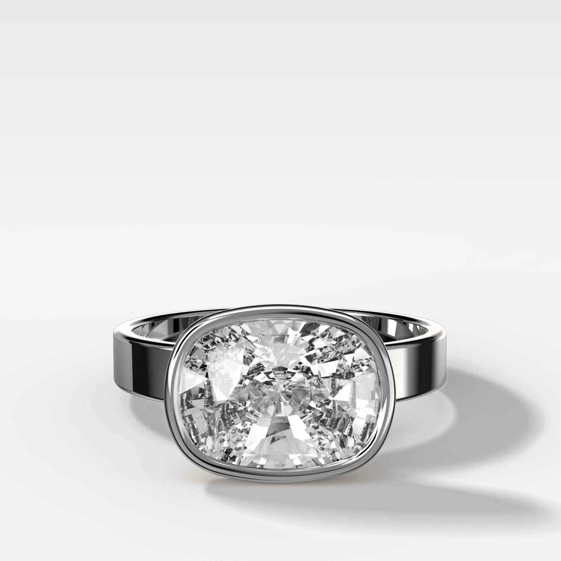 Finest Bezel Set Engagement Ring With East West Elongated Cushion Cut Diamond