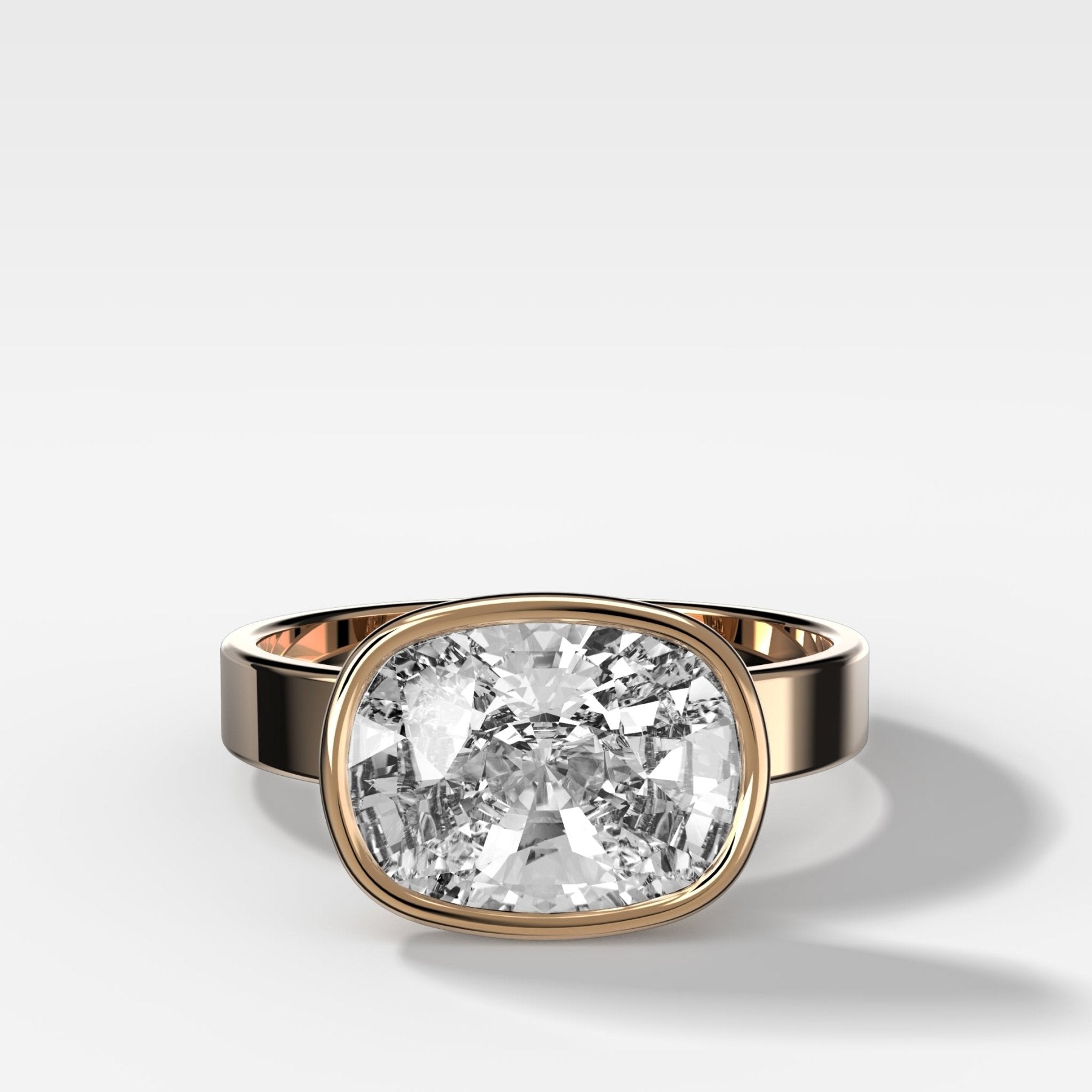 Finest Bezel Set Engagement Ring With East West Elongated Cushion Cut Diamond