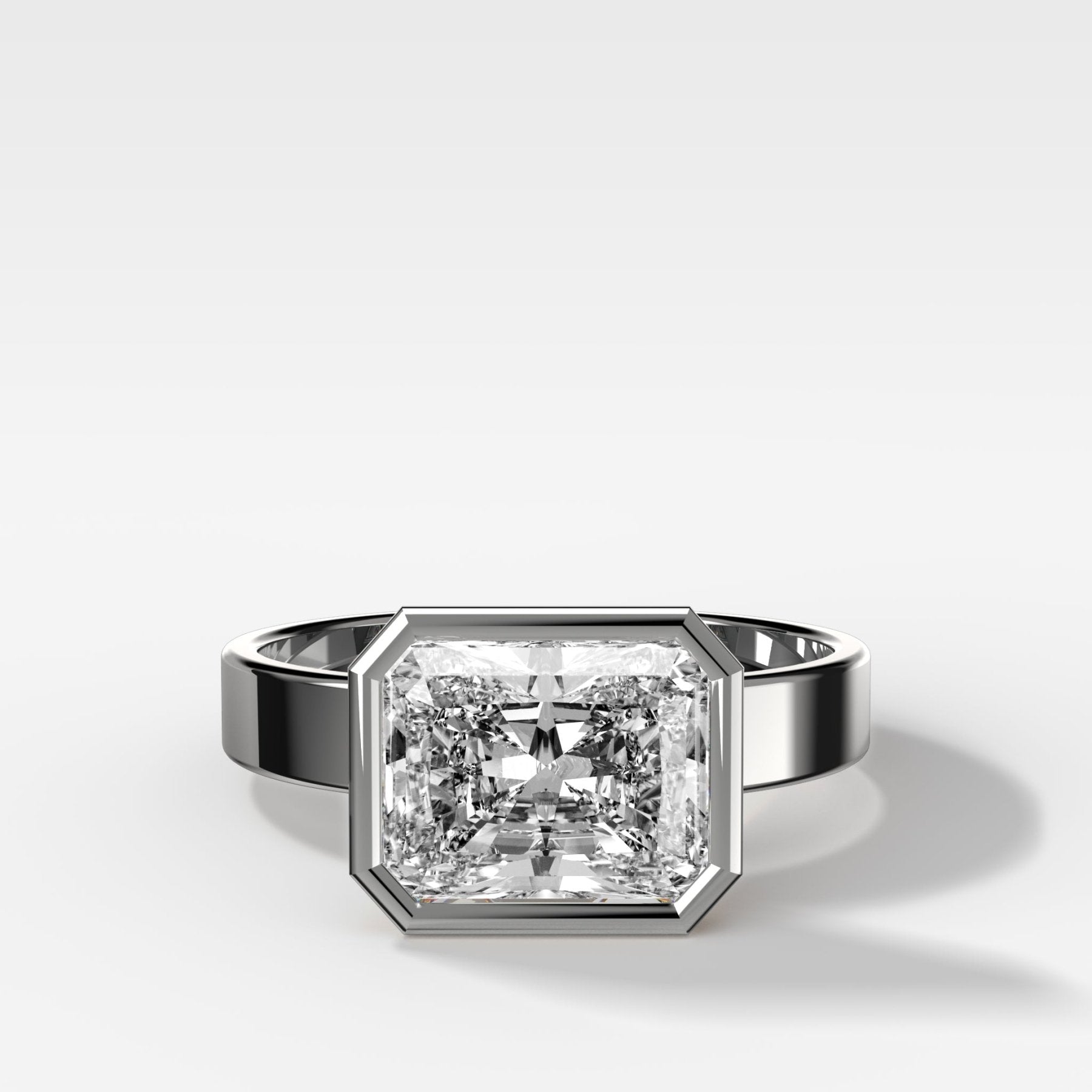 Finest Bezel Set Engagement Ring With East West Elongated Radiant Cut Diamond