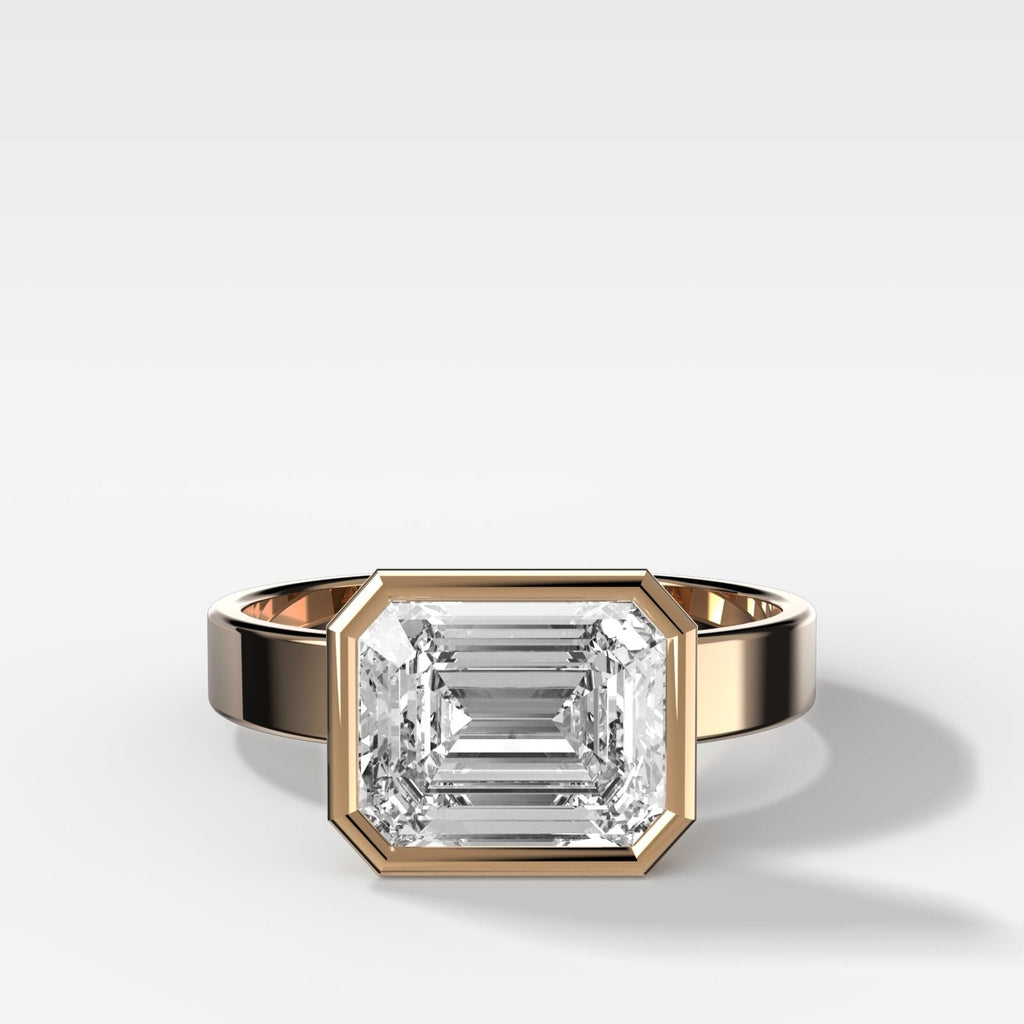 Finest Bezel Set Engagement Ring With East West Emerald Cut Diamond