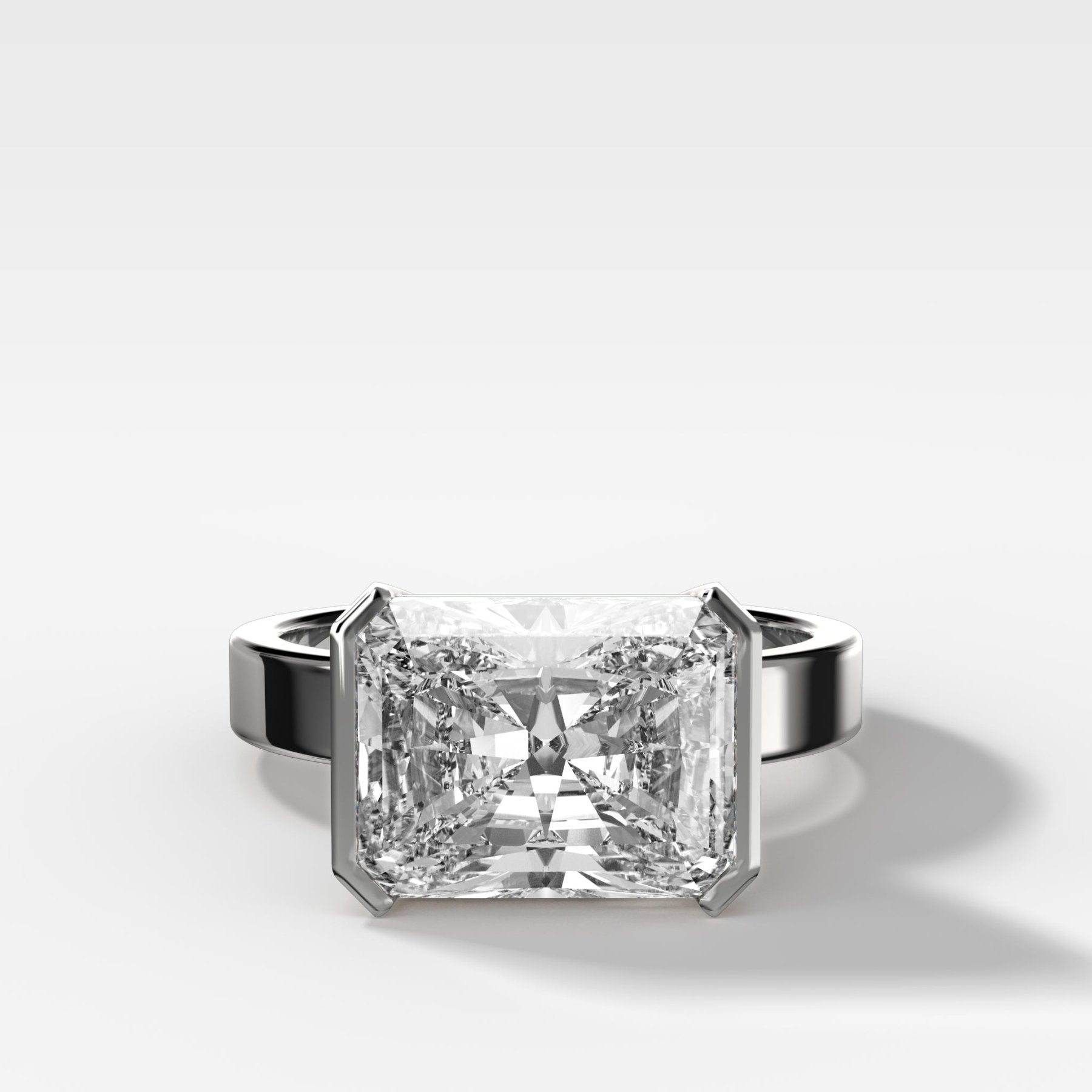 Finest Half Bezel Solitaire Engagement Ring With East West Elongated Radiant Cut Diamond