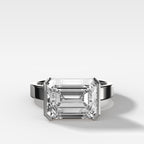 Finest Half Bezel Solitaire Engagement Ring With East West Emerald Cut Diamond