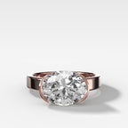 Finest Half Bezel Solitaire Engagement Ring With East West Oval Cut Diamond
