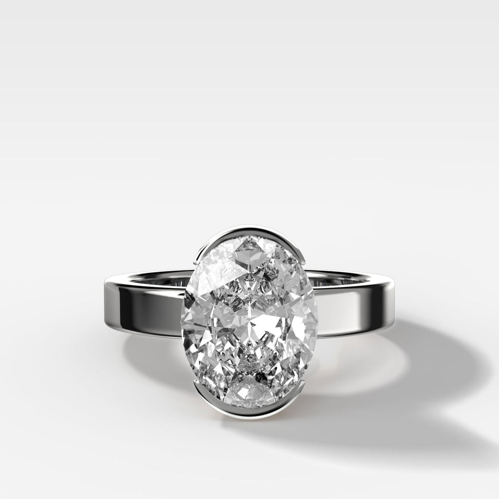 Finest Half Bezel Solitaire Engagement Ring With Oval Cut Diamond