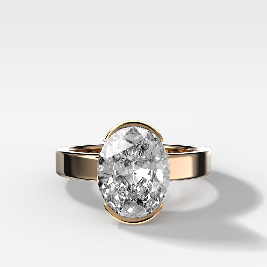 Finest Half Bezel Solitaire Engagement Ring With Oval Cut Diamond