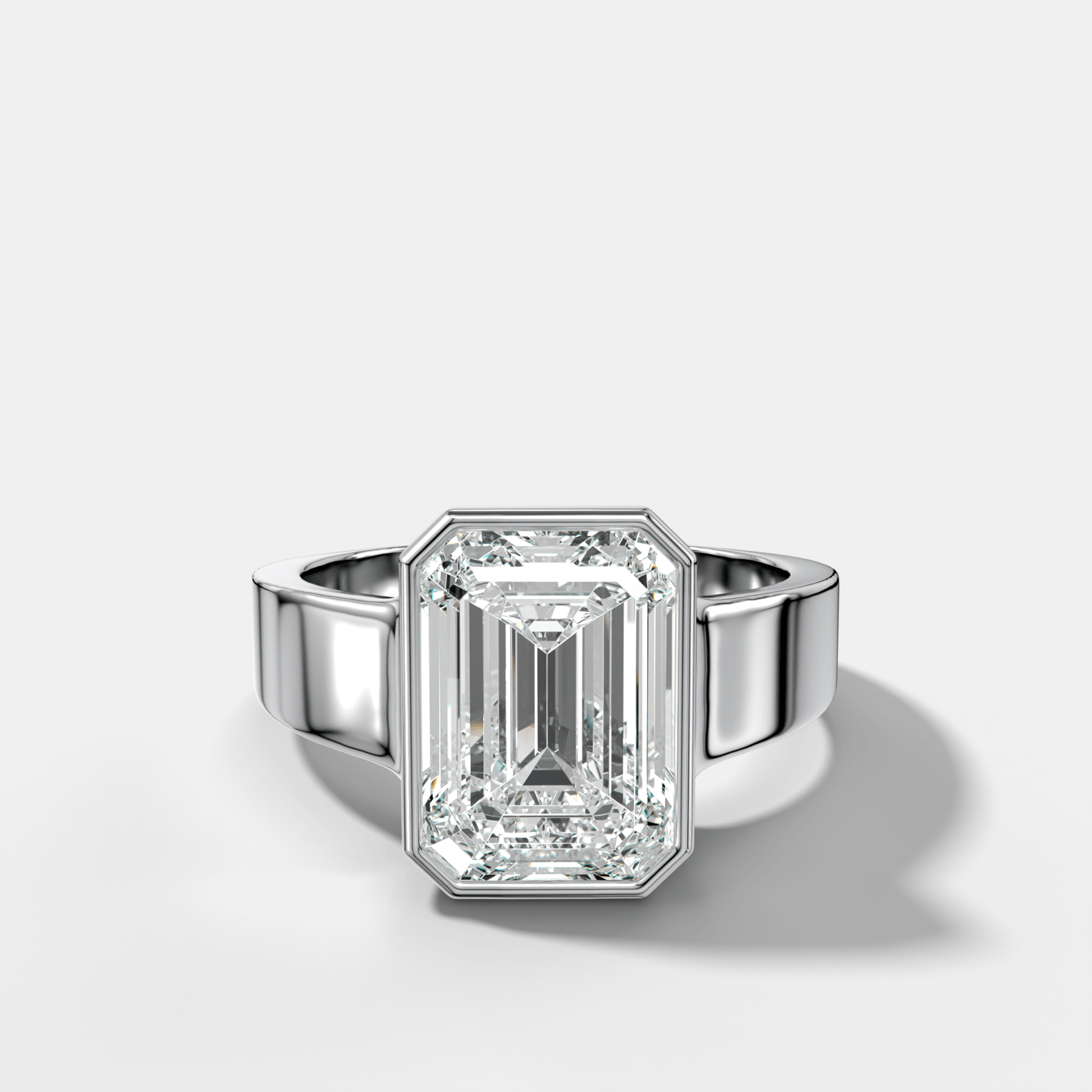 Finest Tapered Bezel Set Engagement Ring With Emerald Cut Diamond