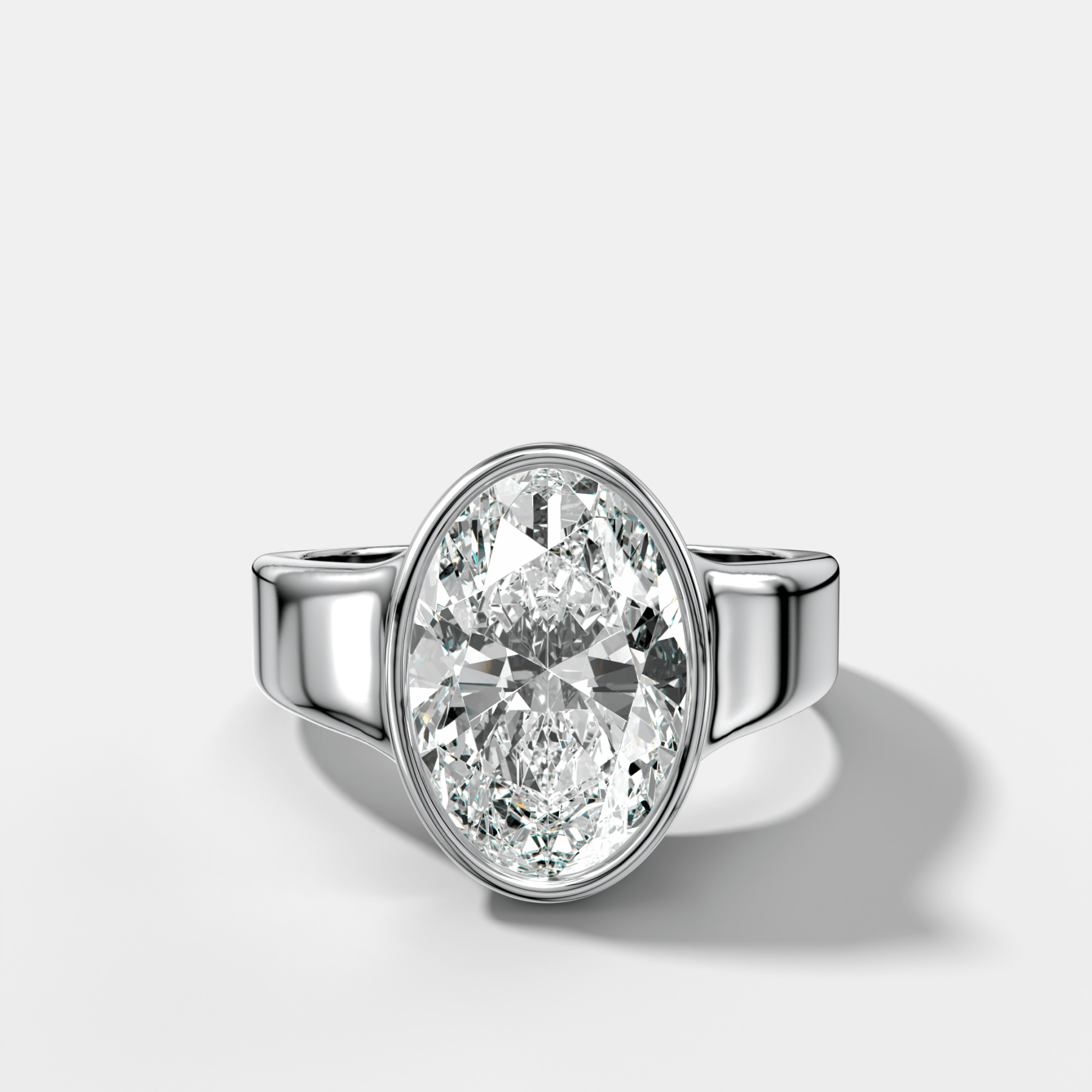 Finest Tapered Bezel Set Engagement Ring With Oval Cut Diamond