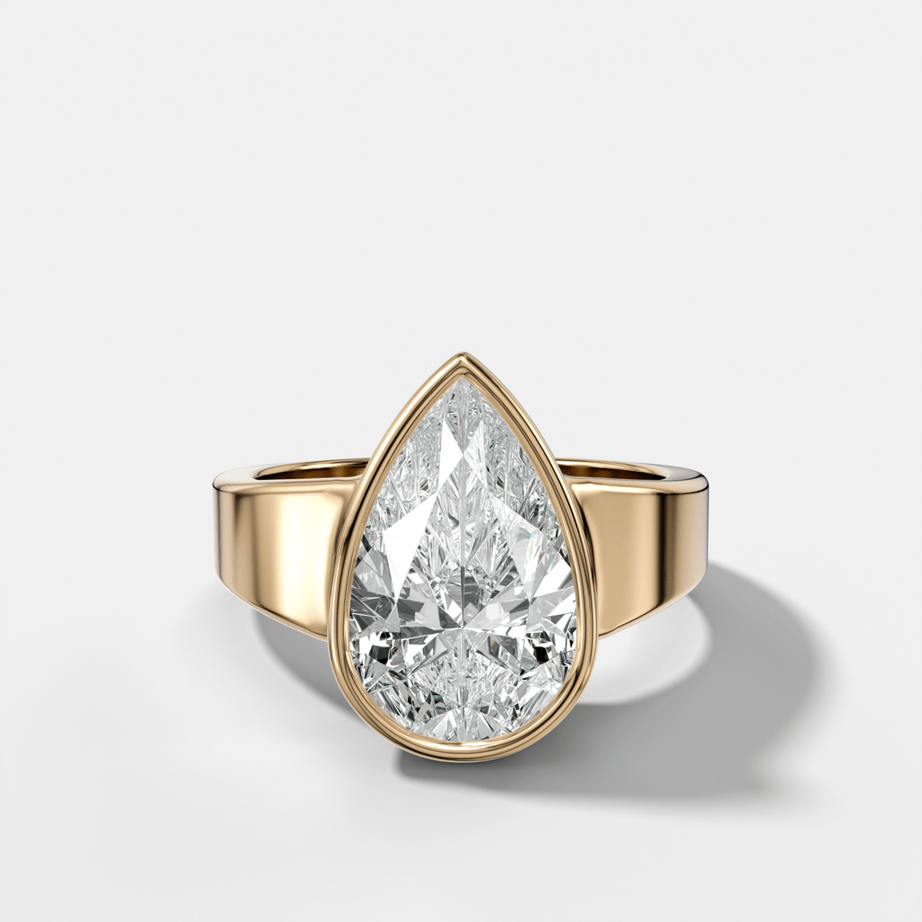Finest Tapered Bezel Set Engagement Ring With Pear Cut Diamond