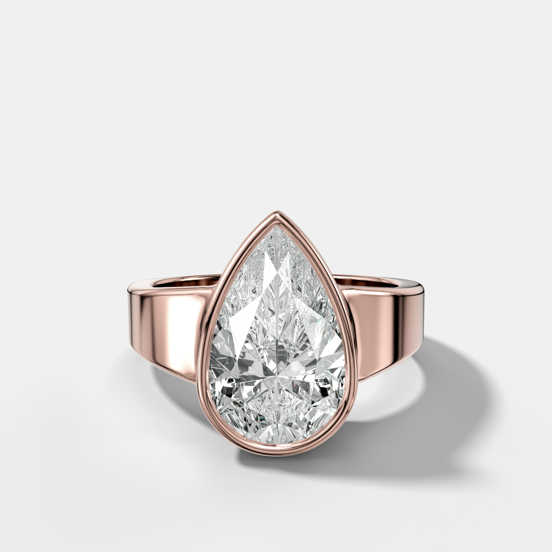 Finest Tapered Bezel Set Engagement Ring With Pear Cut Diamond