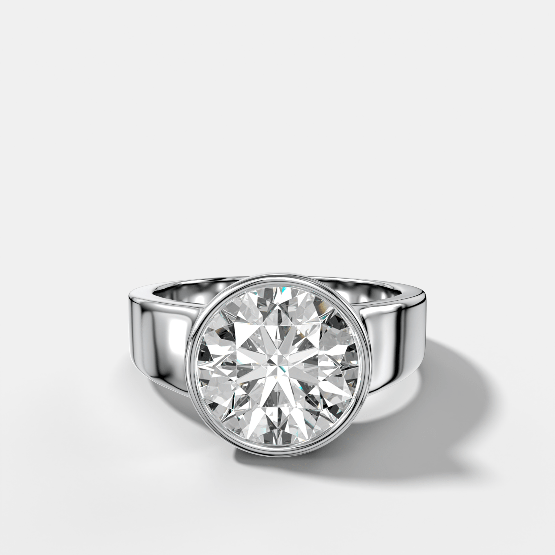 Finest Tapered Bezel Set Engagement Ring With Round Cut Diamond
