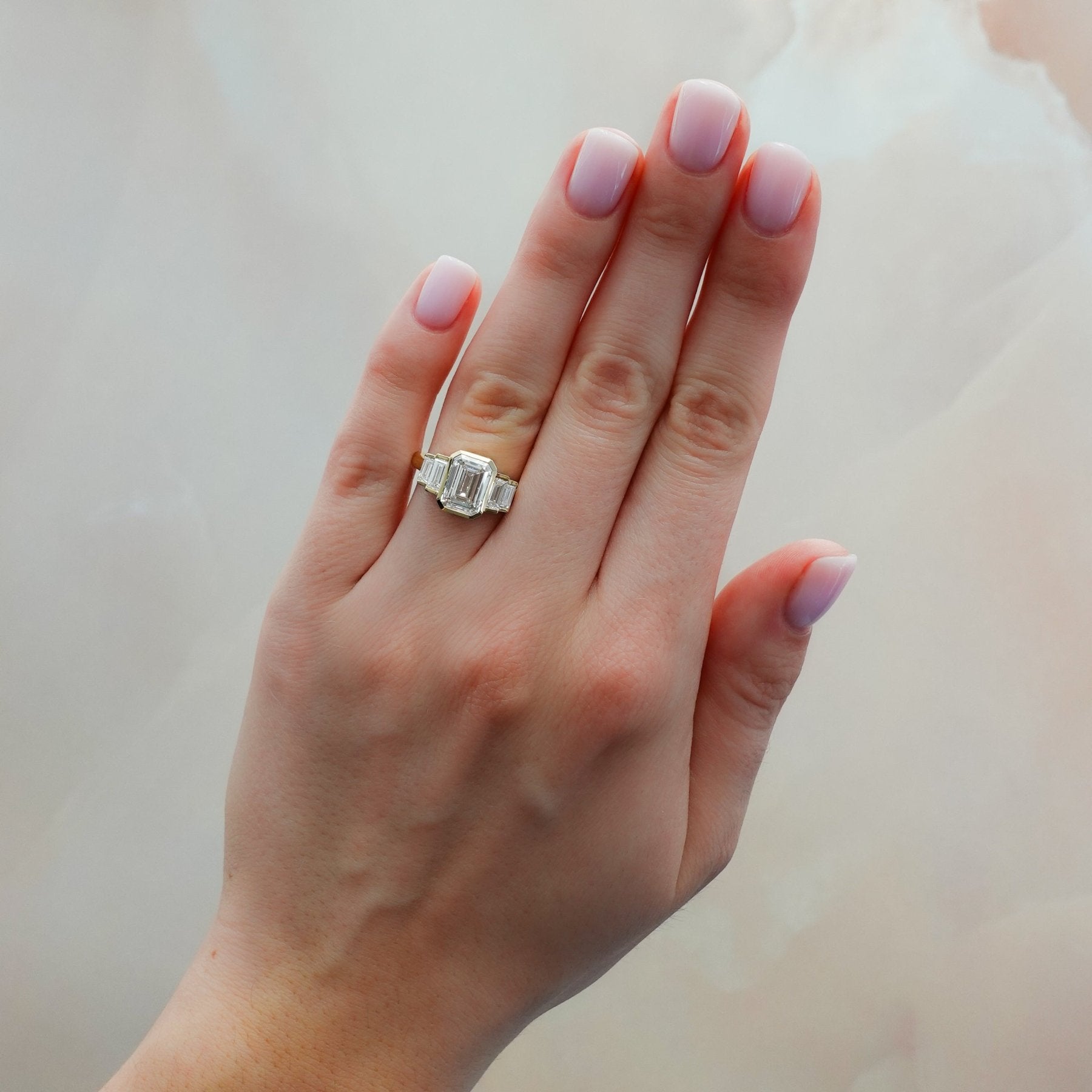 Five Stone Engagement Ring with Half Bezel Baguette Side Stones and Bezel Set Emerald Cut Diamond