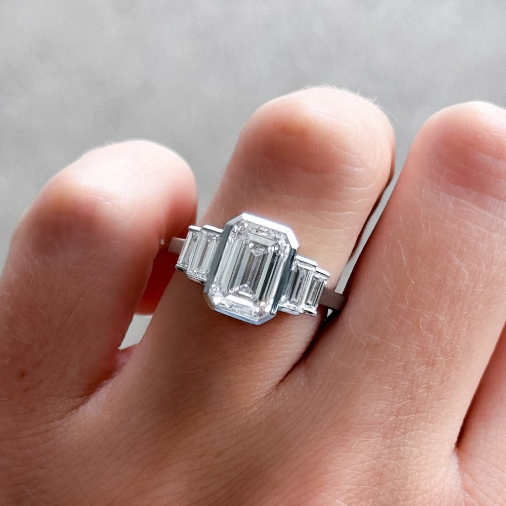 Five Stone Engagement Ring with Half Bezel Baguette Side Stones and Bezel Set Emerald Cut Diamond